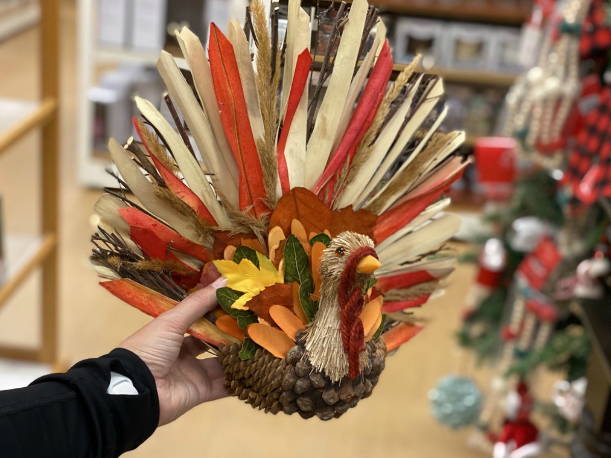 lady holding a Thanksgiving Day turkey decor
