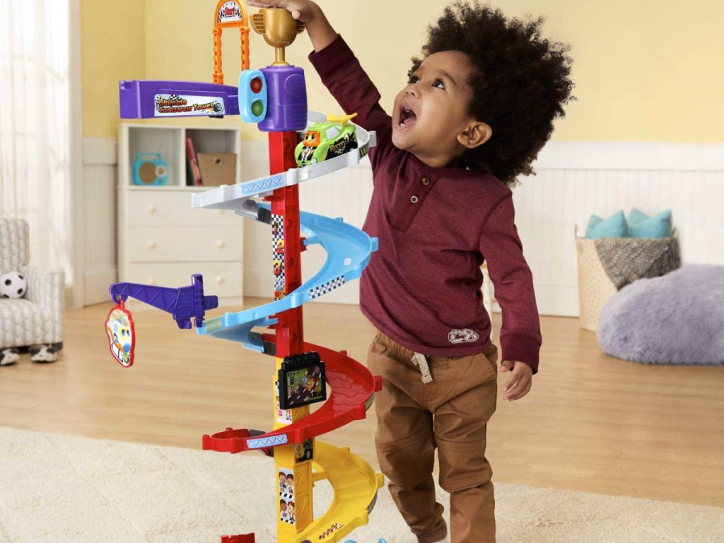 kid playing with a VTech Go! Go! Smart Wheels Ultimate Corkscrew Tower