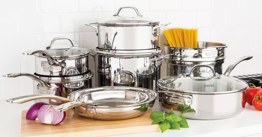 stainless steel 13 piece cookware set on kitchen counter near veggies and pasta