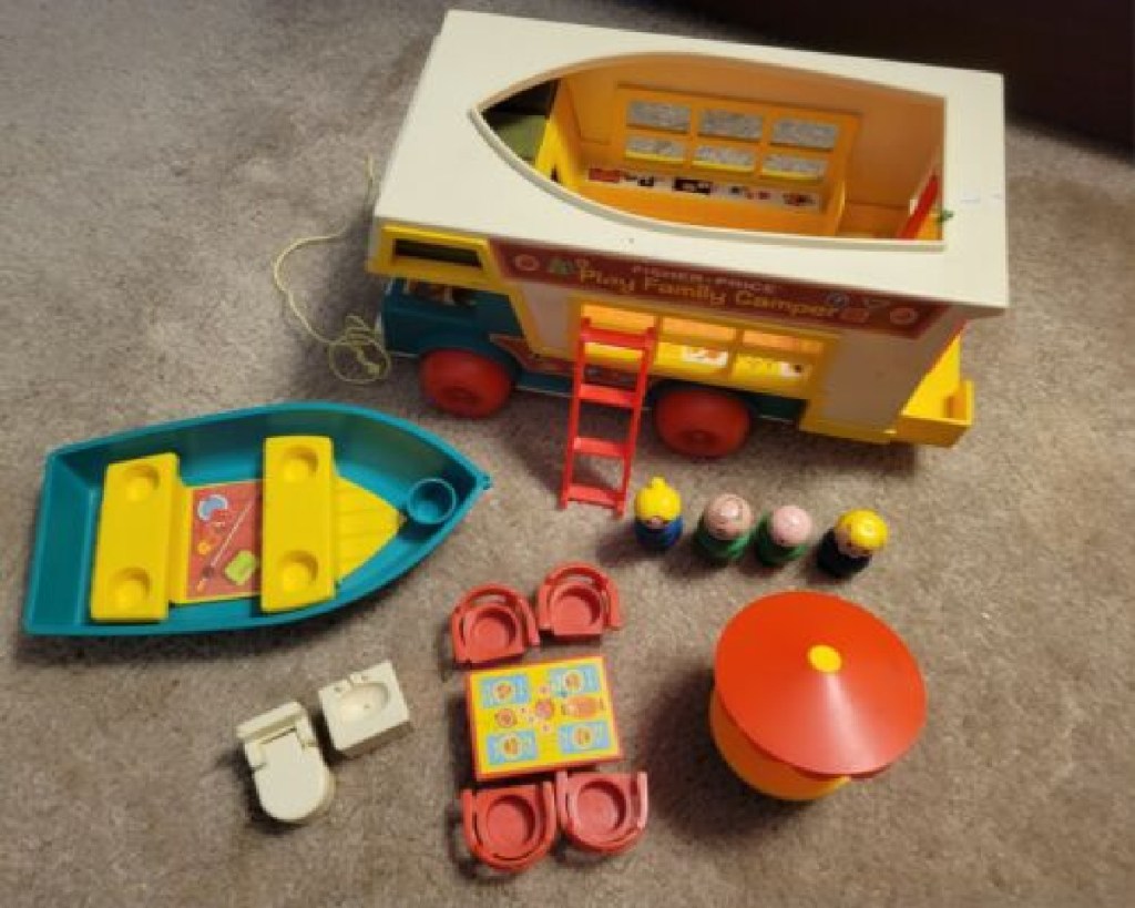 Vintage Fisher Price Family Camper displayed on carpet