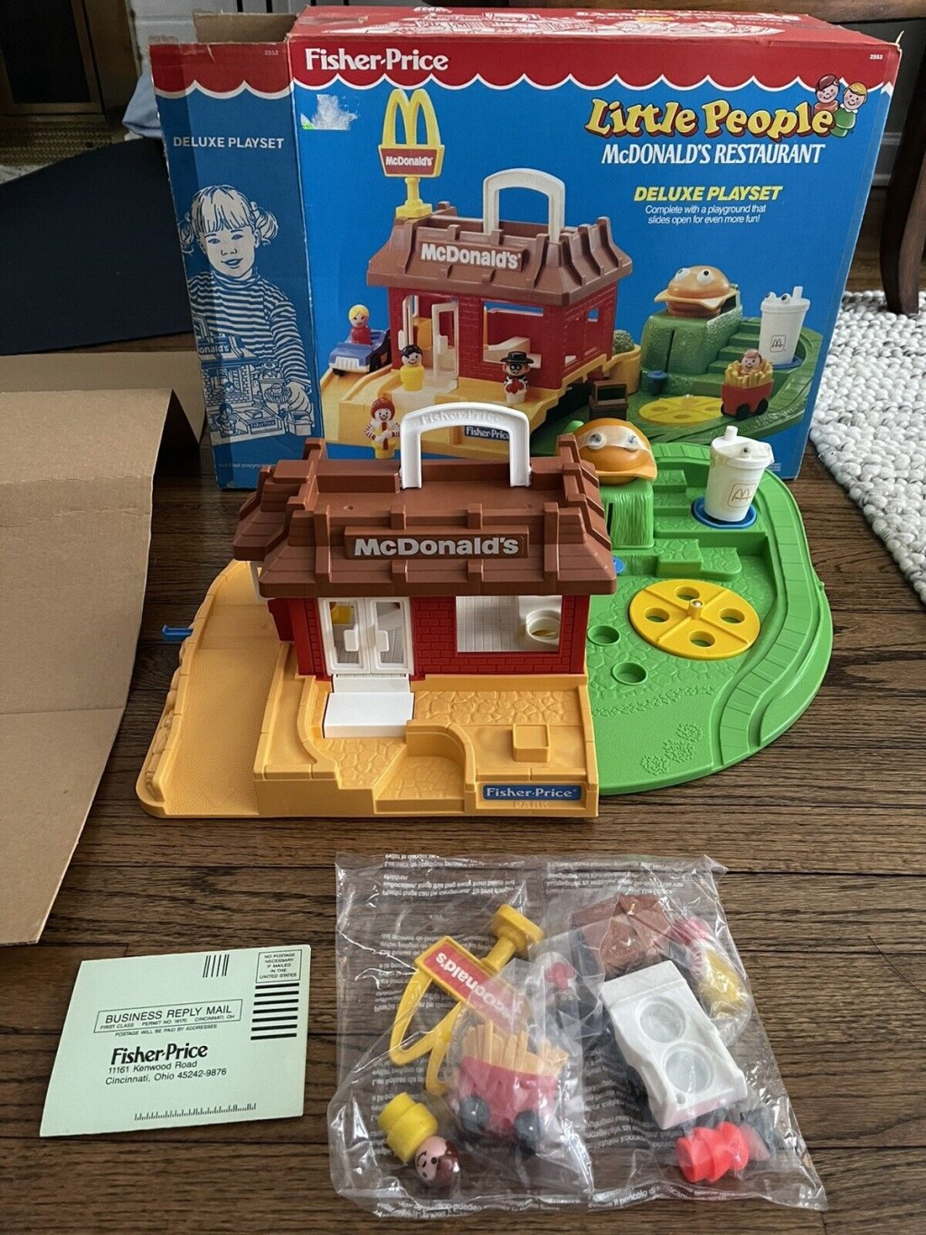 A vintage fisher price mcdonald's playset displayed on a table with its original box