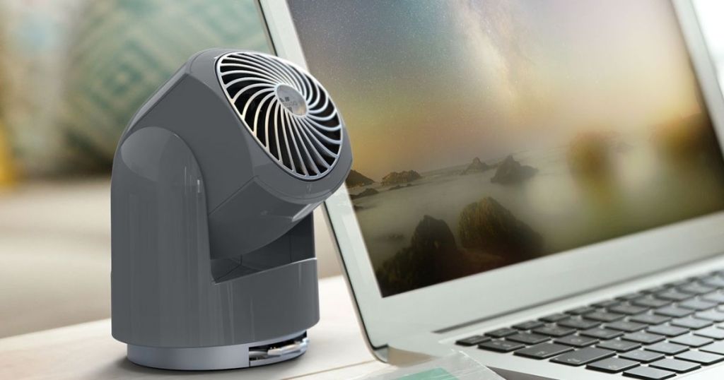 small fan on desk near laptop