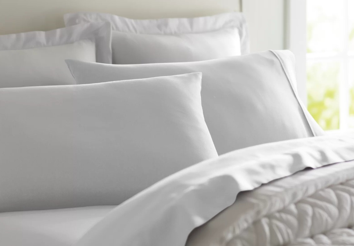 bed with white sheets on it