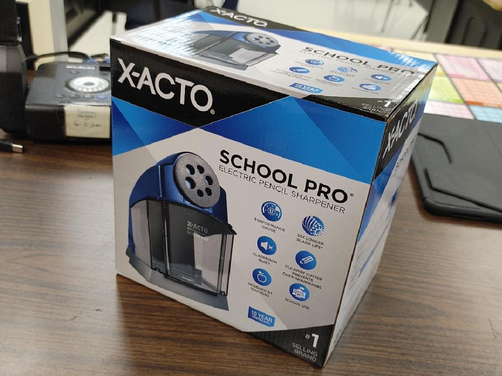 electric pencil sharpener box on table in classroom
