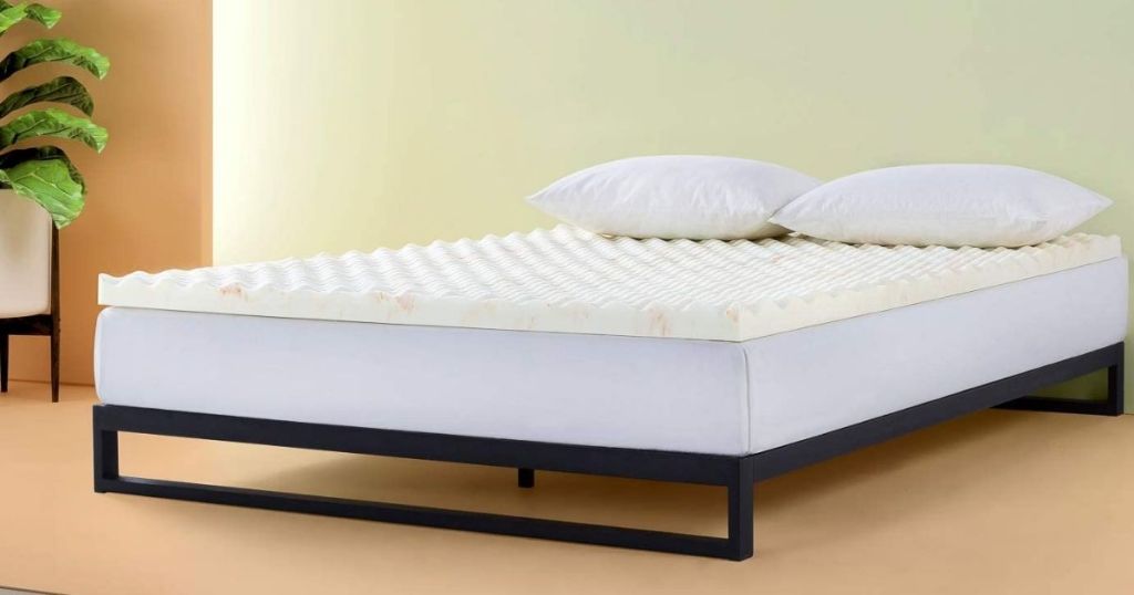 Zinus mattress topper on platform bed by a plant