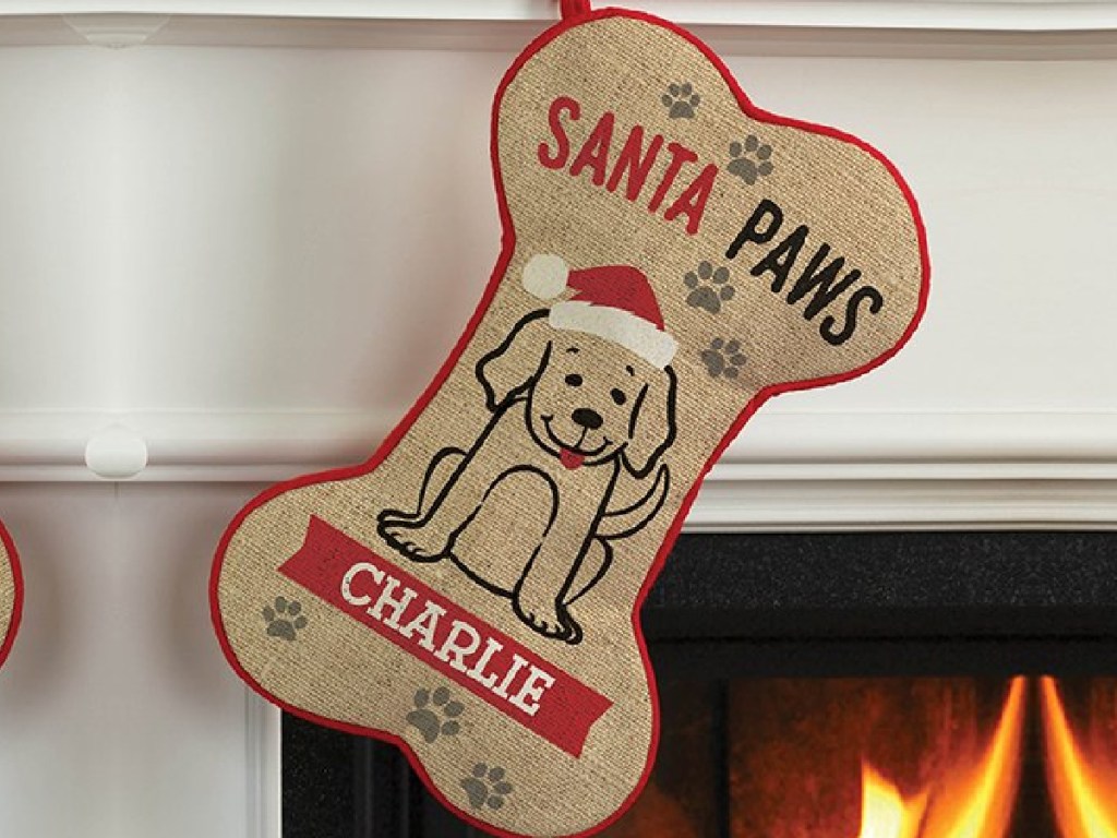 burlap santa paws personalized stocking hanging on a fireplace mantle