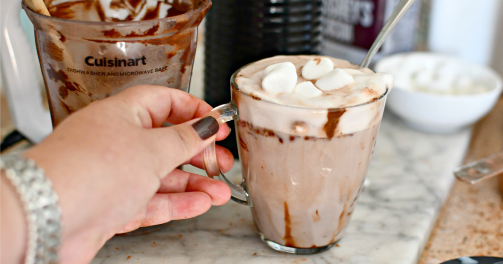 adding marshmallows to whipped hot chocolate