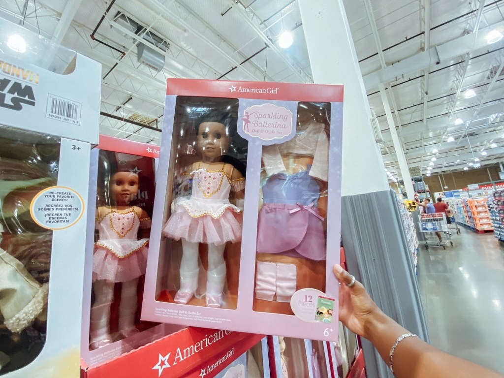 holding an American Girl bundle in the box