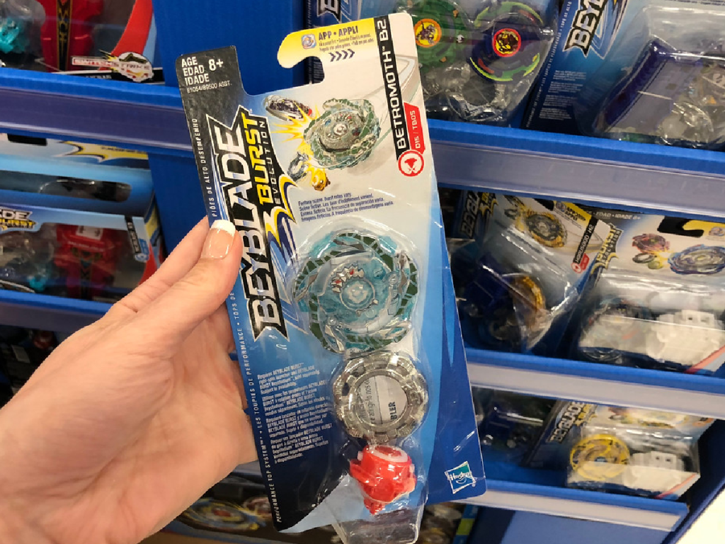 hand holding toy in package by store display