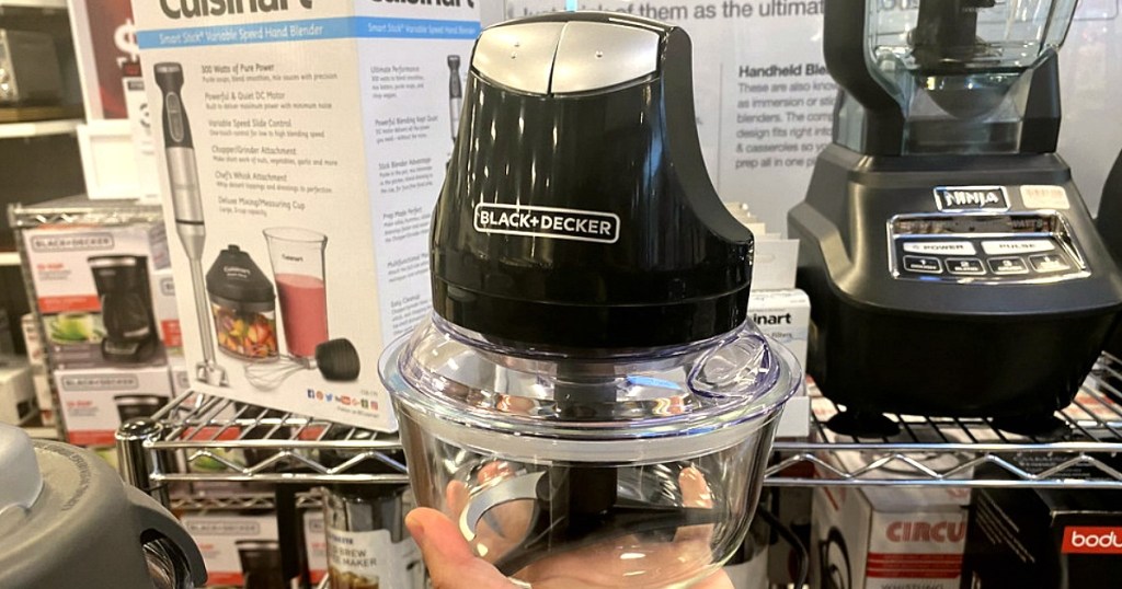 hand holding up a food chopper in store