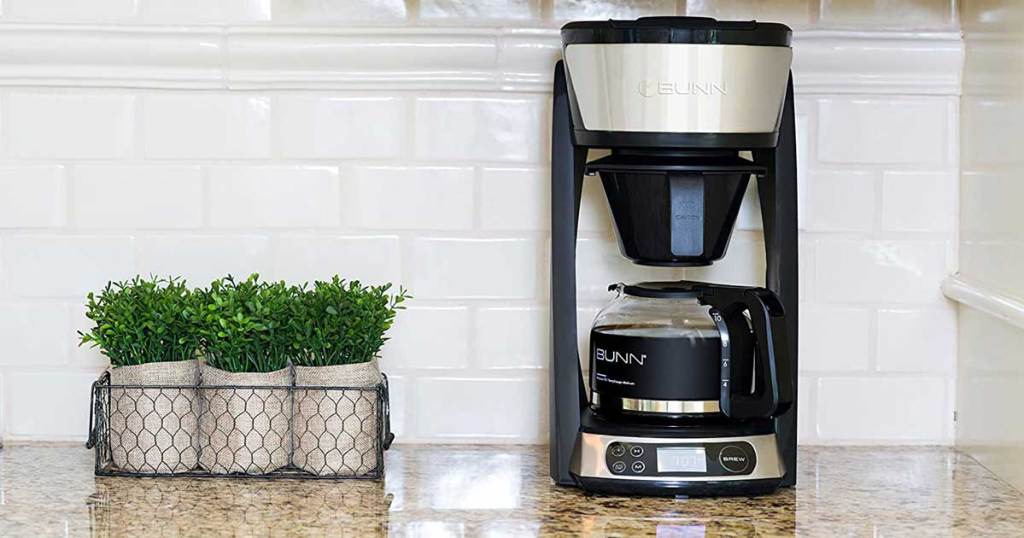 coffeemaker on a counter with decorative piece