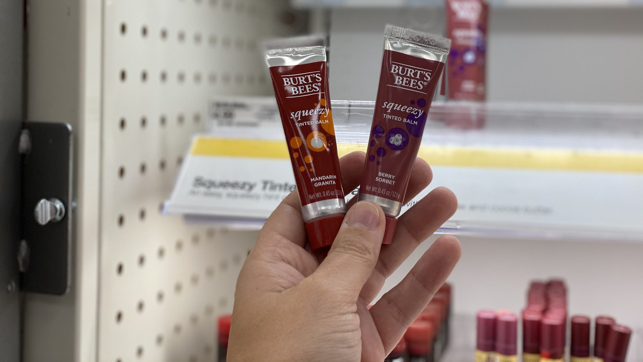 burt's bees squeesy lip balm in hand in store