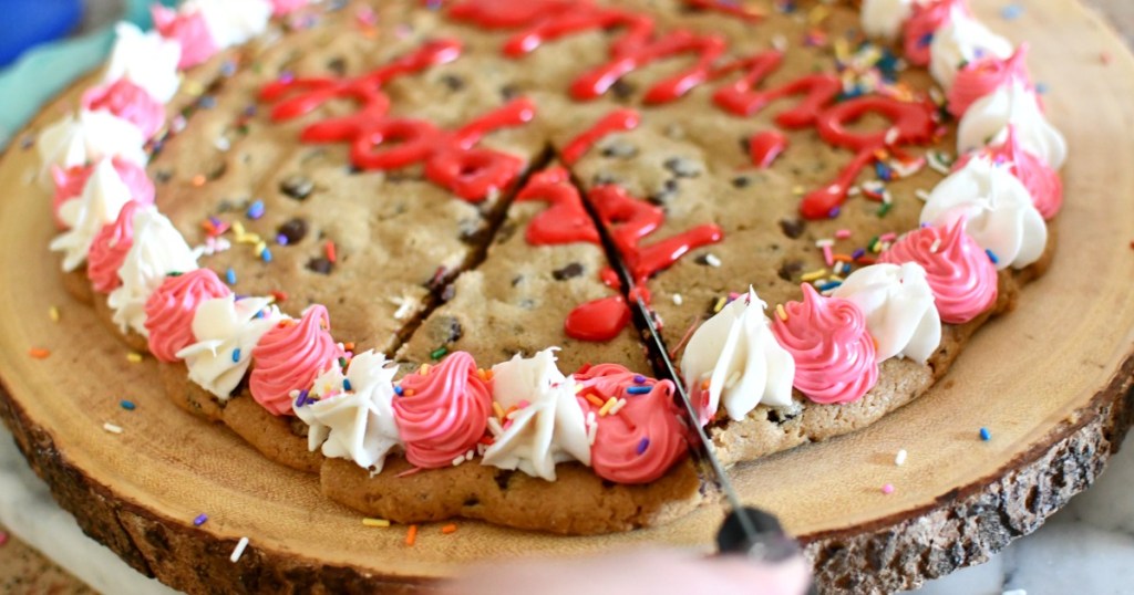 cutting a large cookie cake