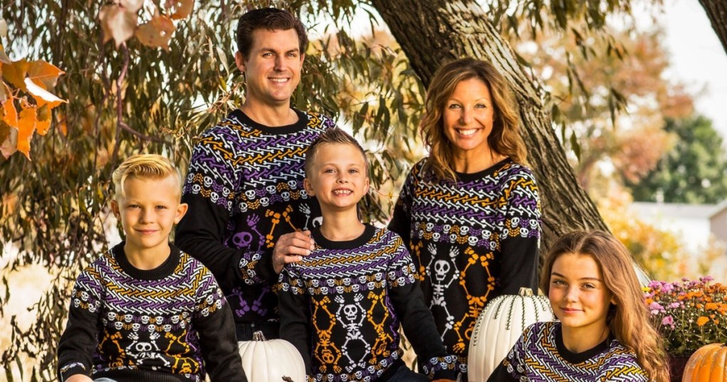 family wearing Halloween sweaters