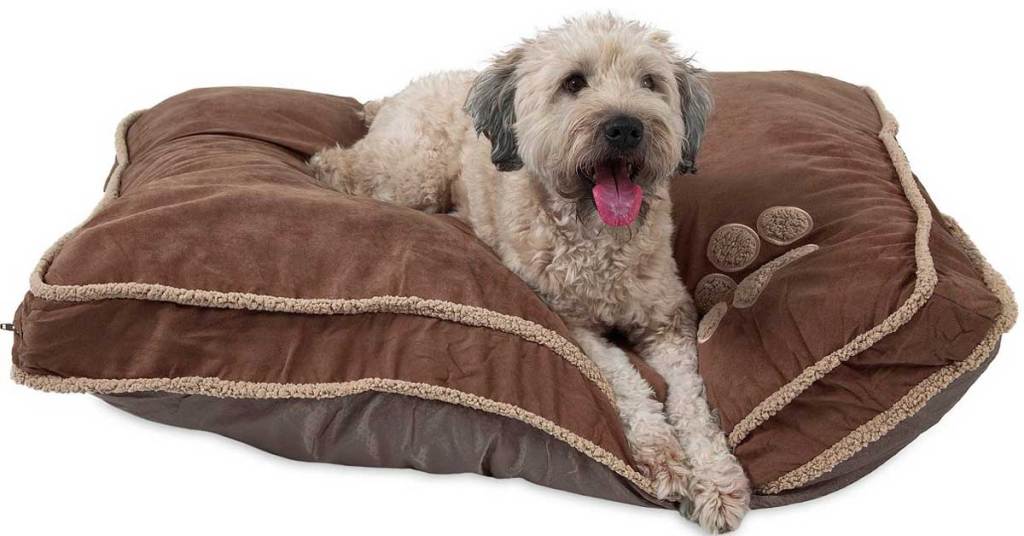 dog laying on brown pet bed