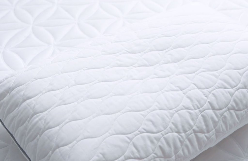 white memory foam pillow on a memory foam bed