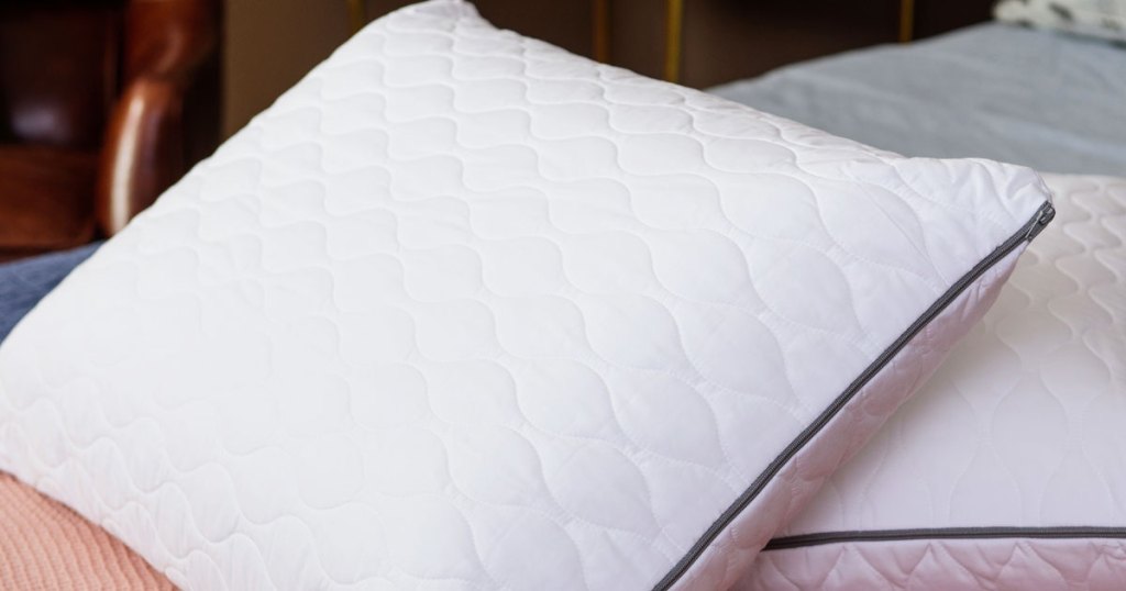 two white memory foam pillows on a bed