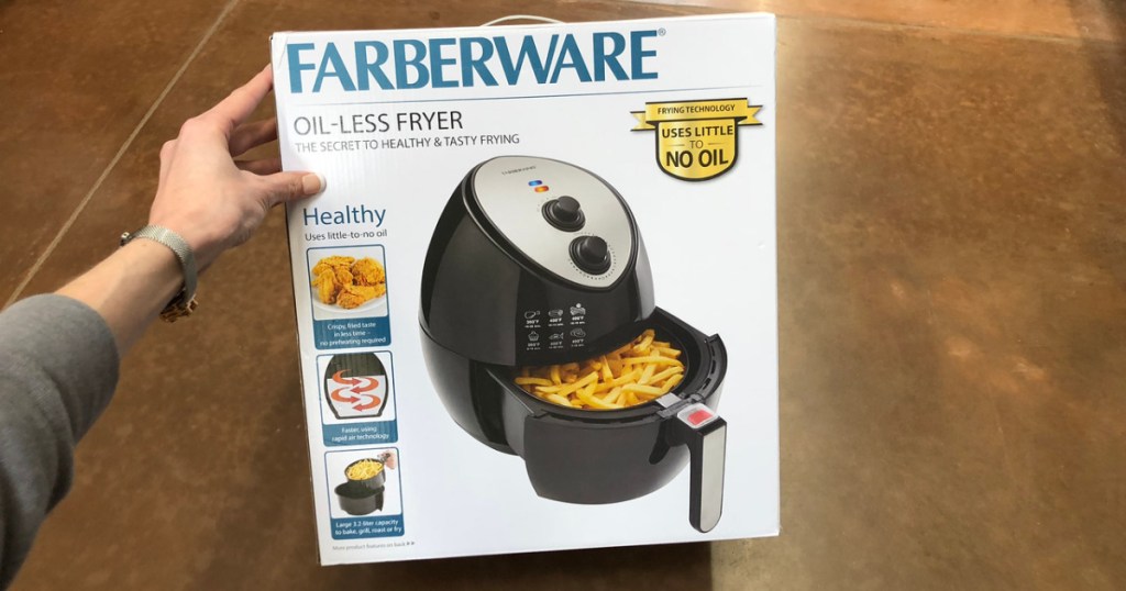 hand holding onto box with air fryer in it