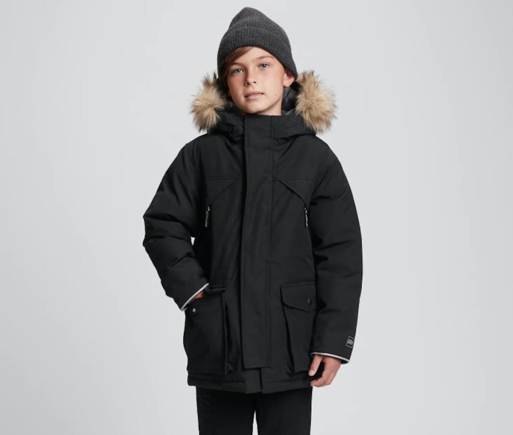 boy modeling black parka jacket with beanie hat