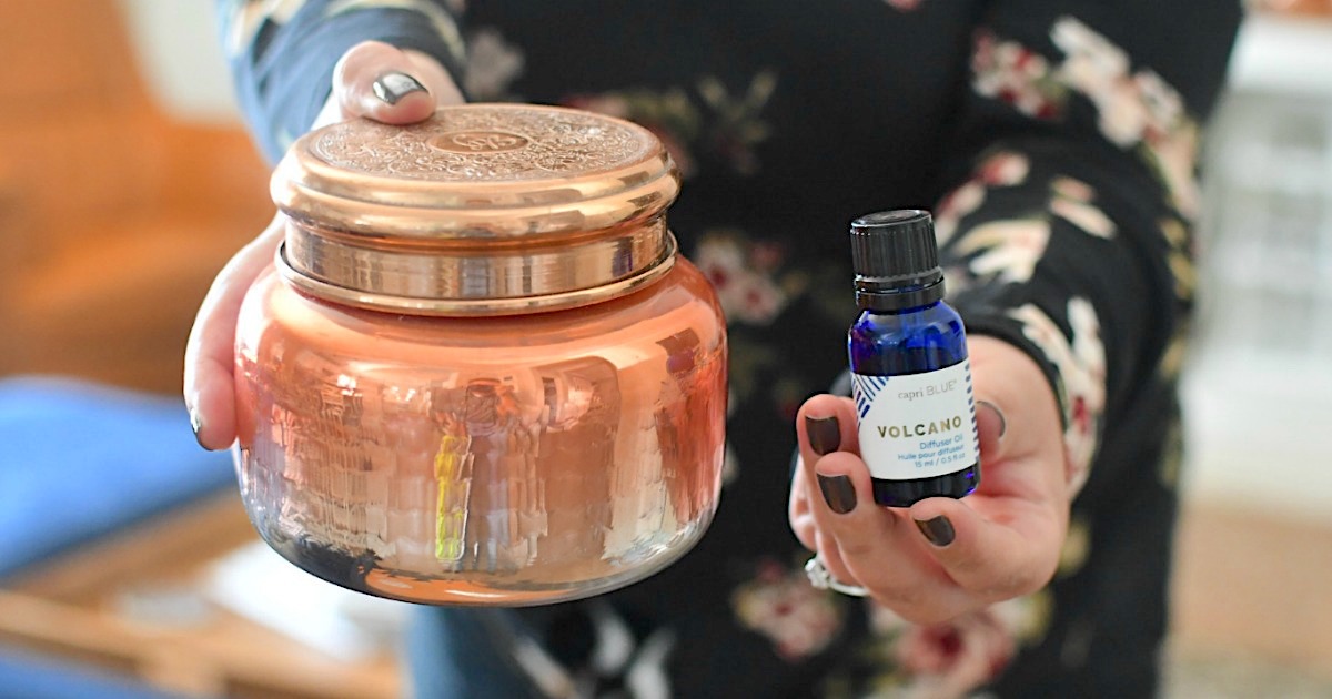holding Anthropologie candle and volcano diffuser oil 