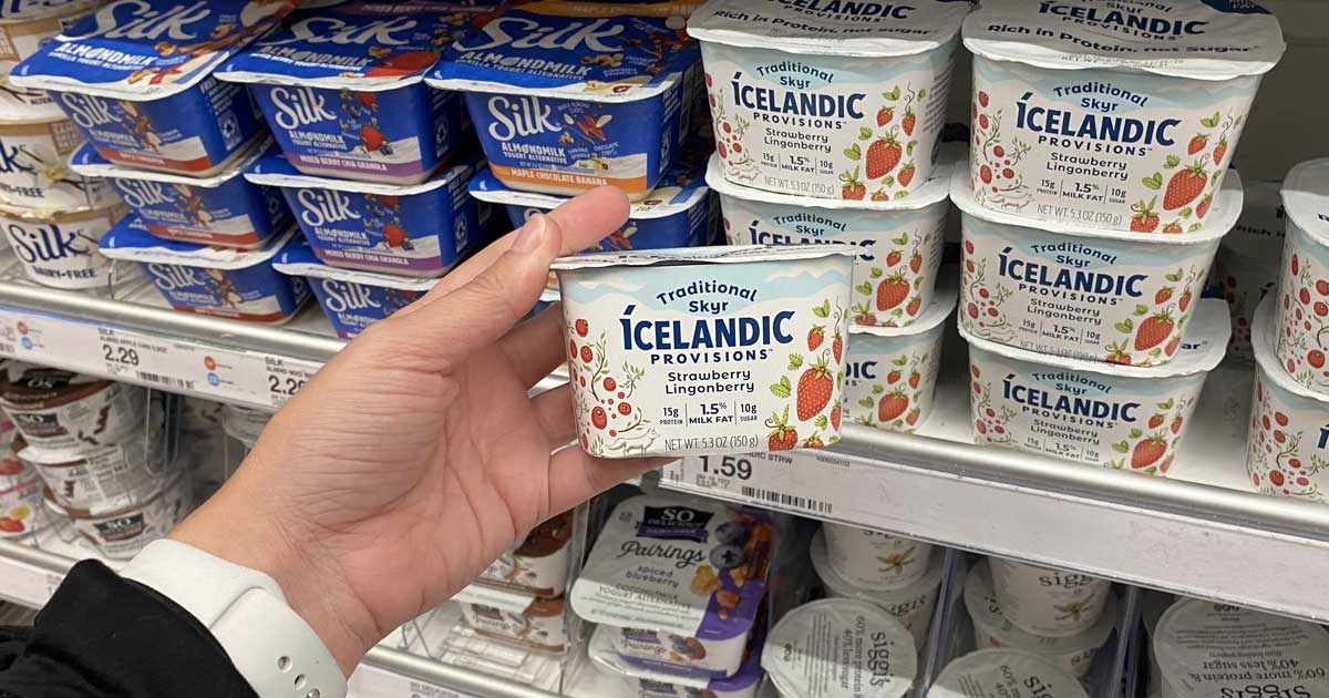 hand holding a cup of yogurt in a store