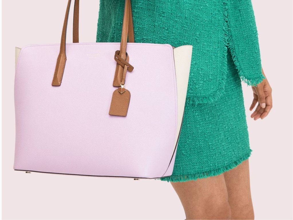 woman carrying pink Kate Spade tote bag