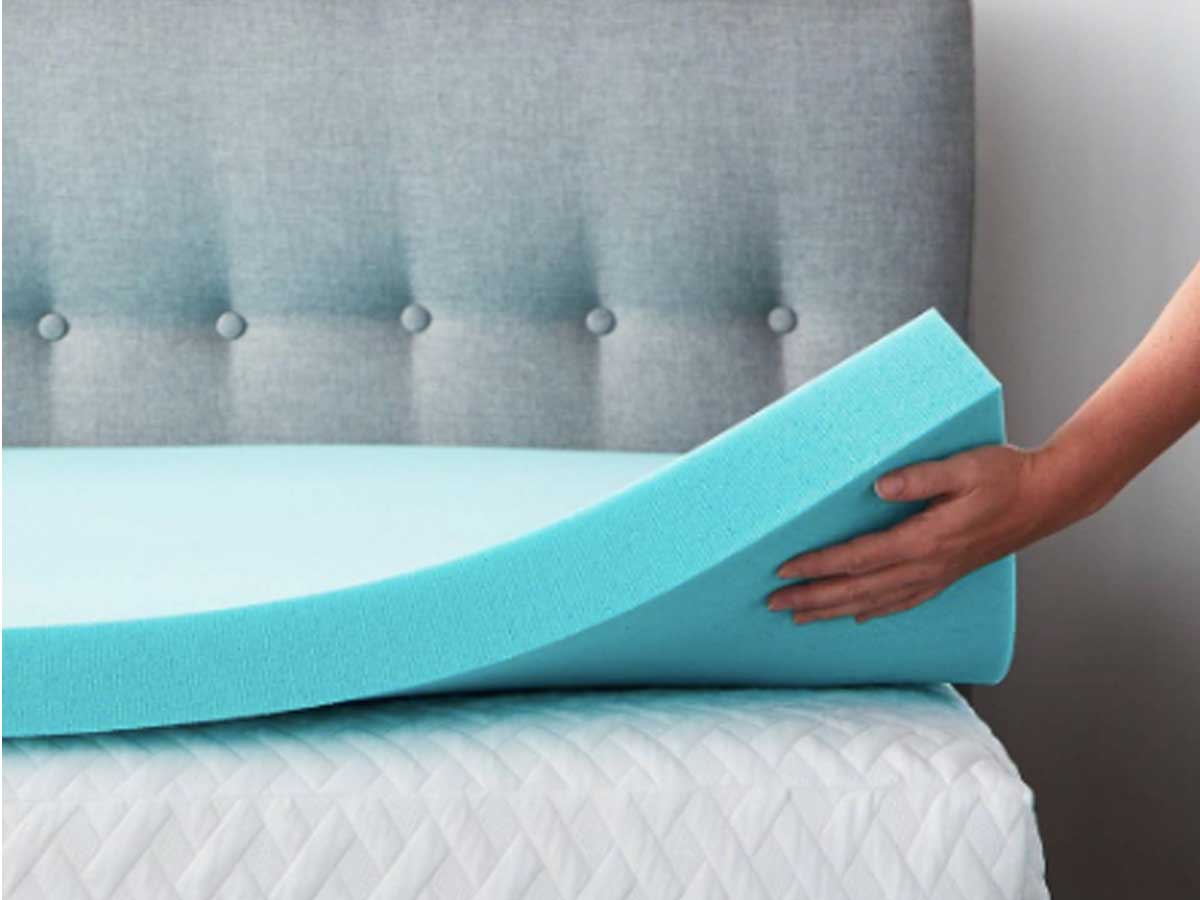 hand holding a mattress topper