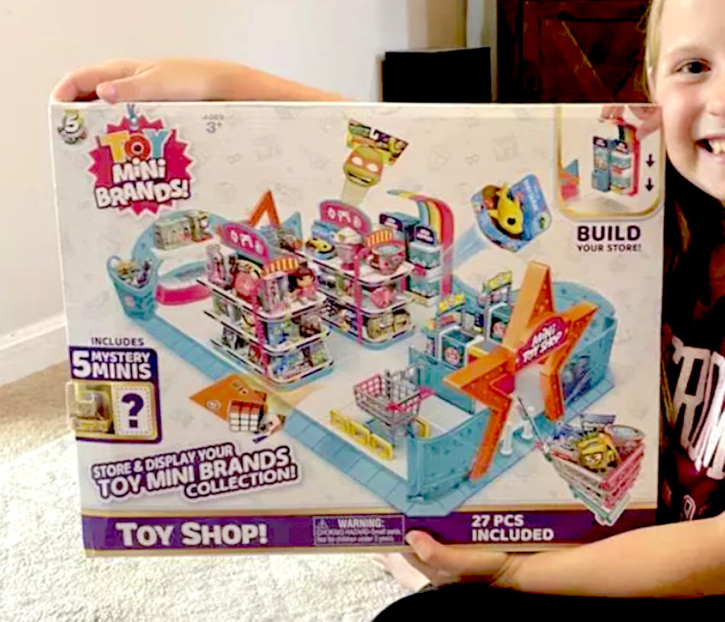 kid holding mini brands toy store box