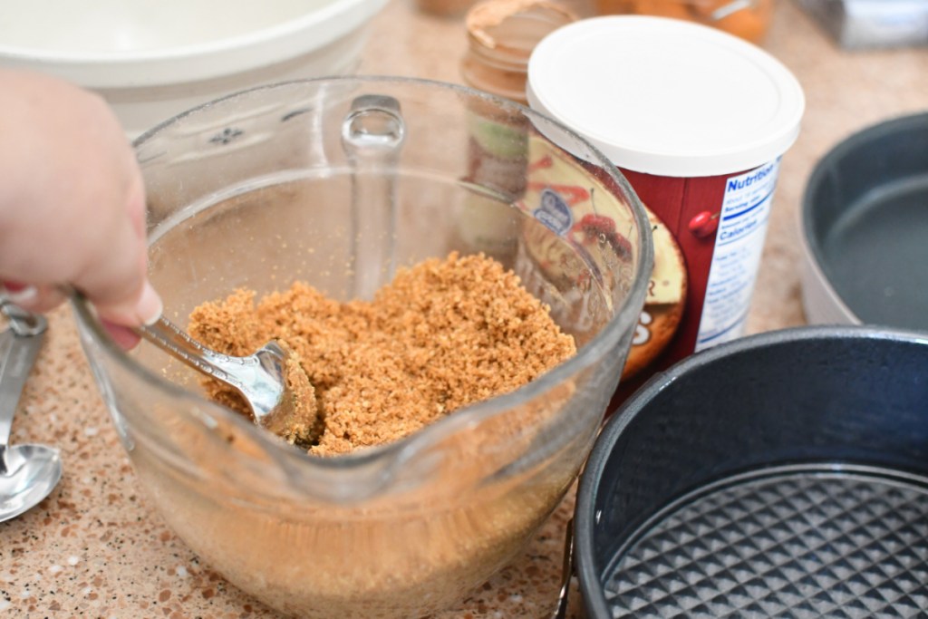 mixing ingredients graham cracker crust