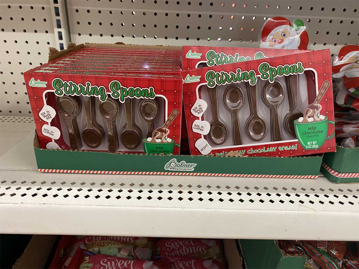 stirring spoons made of chocolate on shelf in store