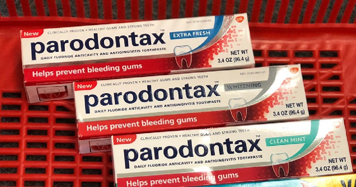 Three boxes of Paradontax toothpaste in a red cart or basket