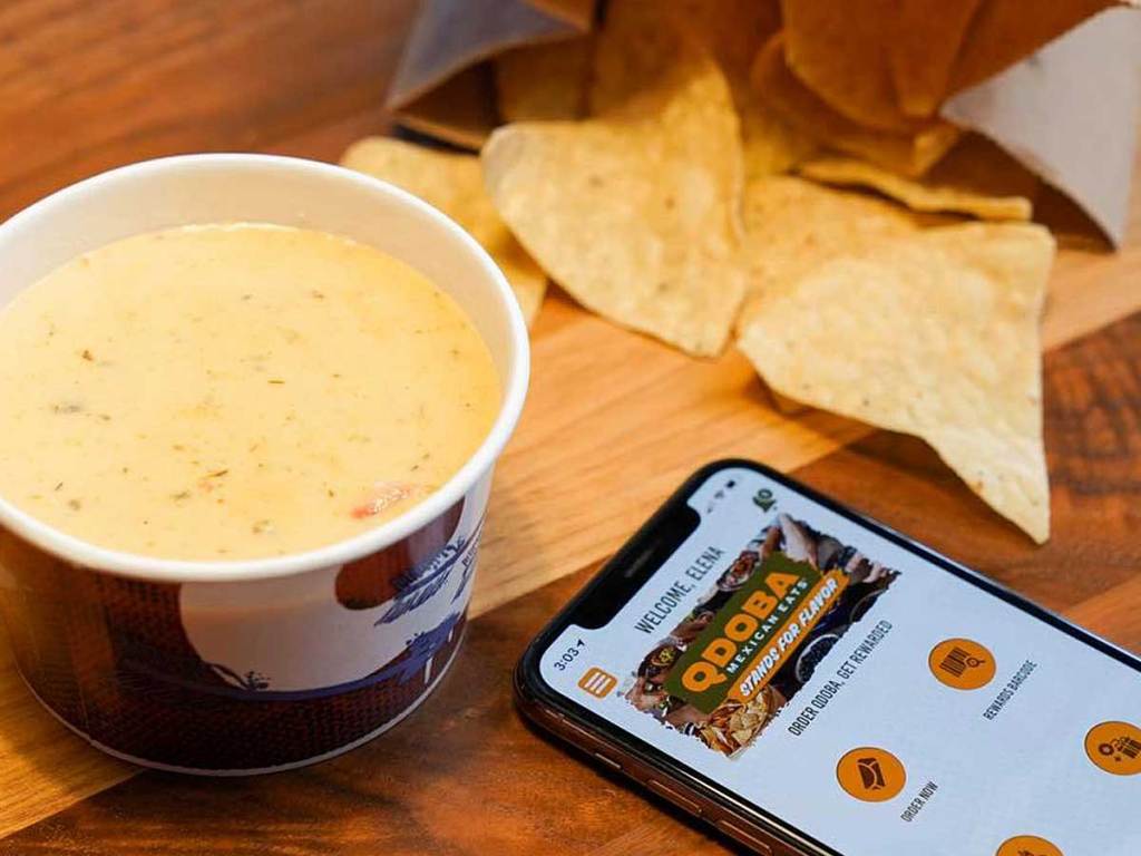 chips queso and a phone on the table