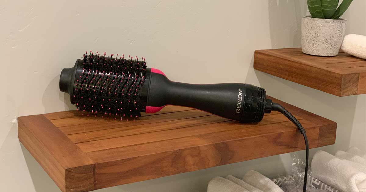 pink version of the revlon hair dryer on wooden shelf