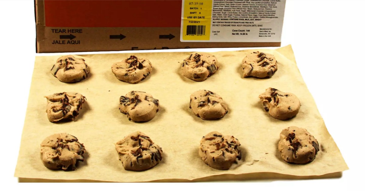 frozen cookies on a sheet of parchment paper in front of a box