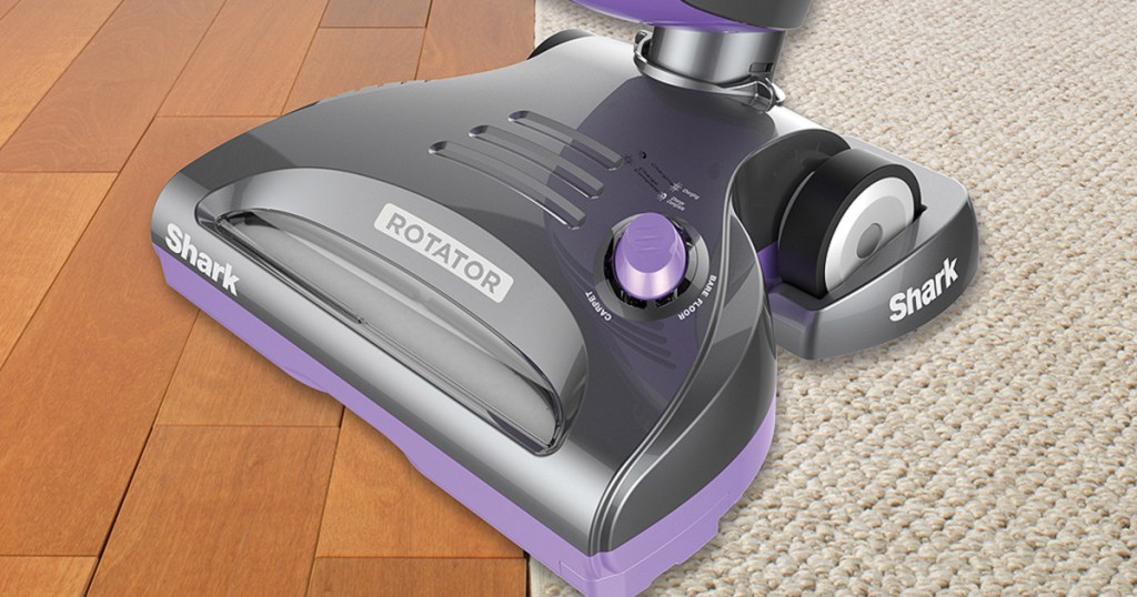 purple and grey vacuum moving across floor