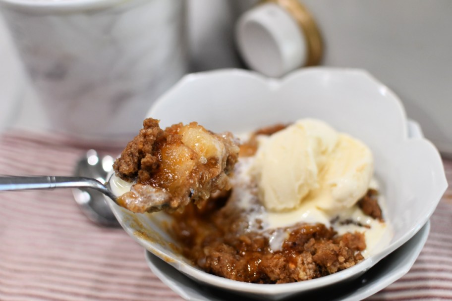 spoonful of crockpot apple dump cake with ice cream