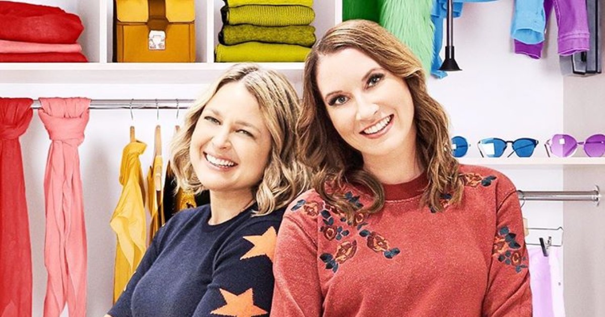 stars of The Home Edit in front of a wall of colorful, organized items