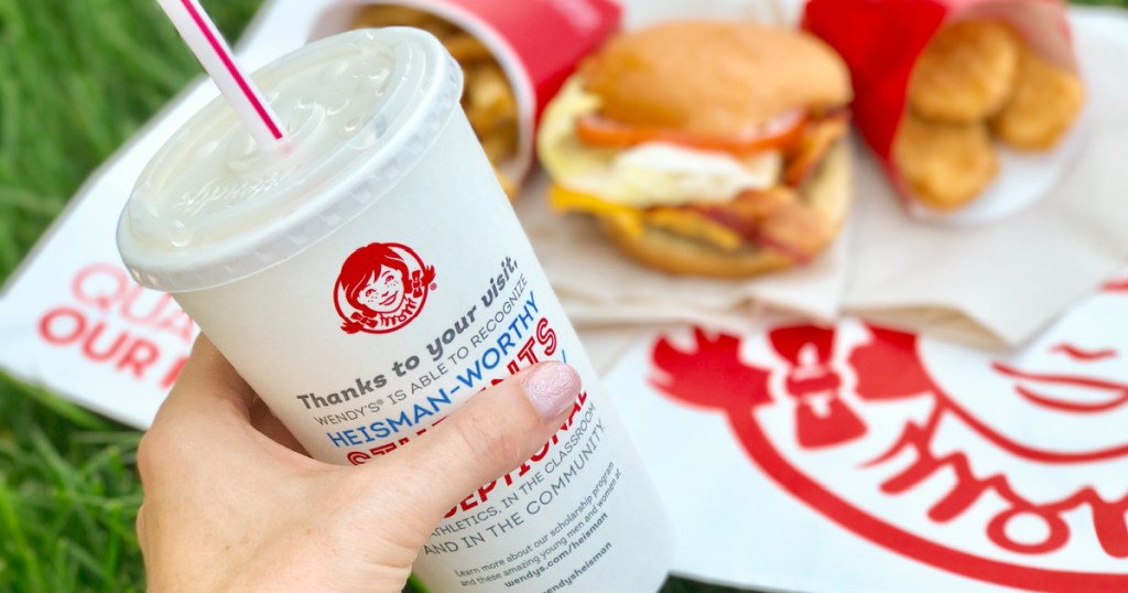 wendy's meal with drink in hand