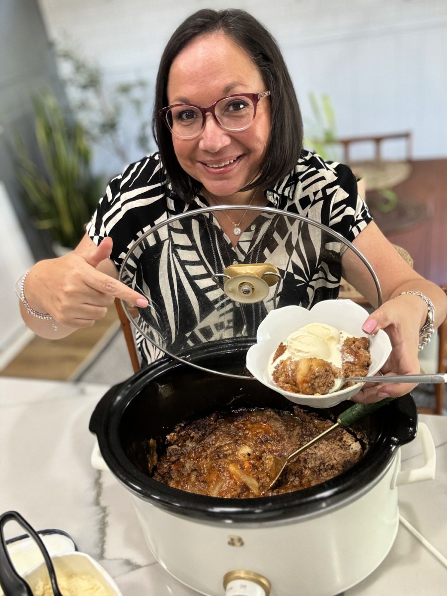 woman making apple dump cake in the slow cooker 