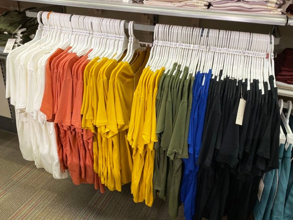various colors of women's basic tees on white hangers on display rack at target