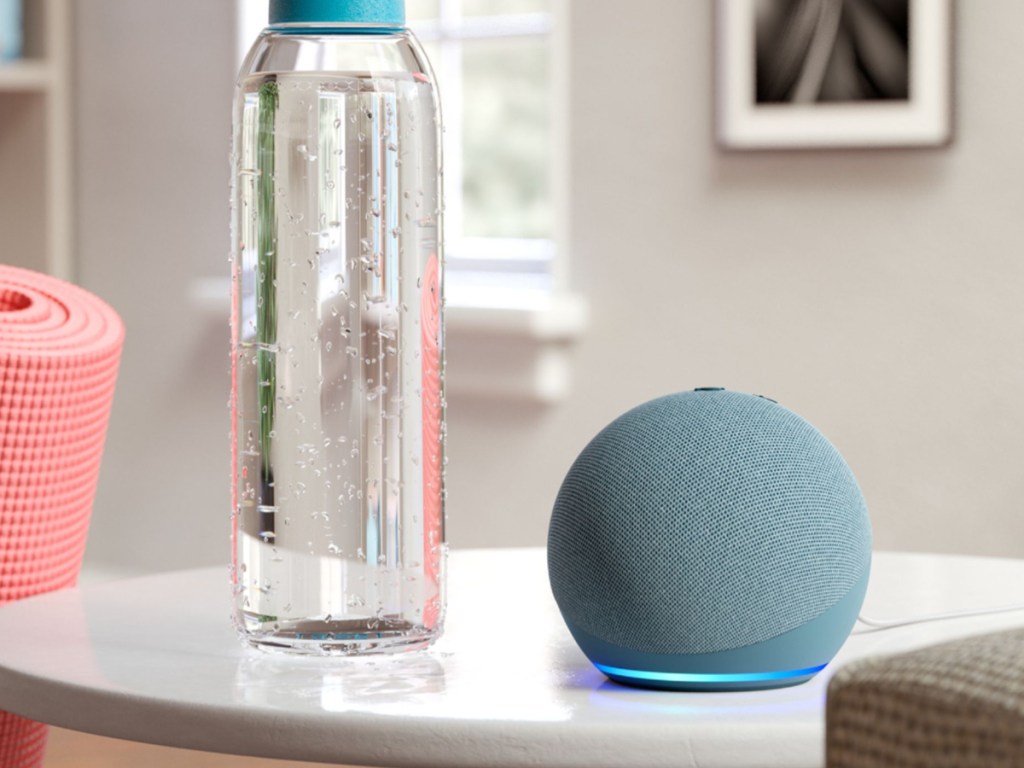 Light blue echo dot 4th generation sitting next to a water bottle