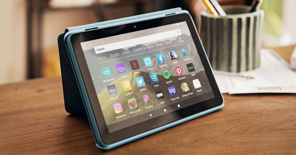 amazon fire tablet in blue case with kickstand on a wood table