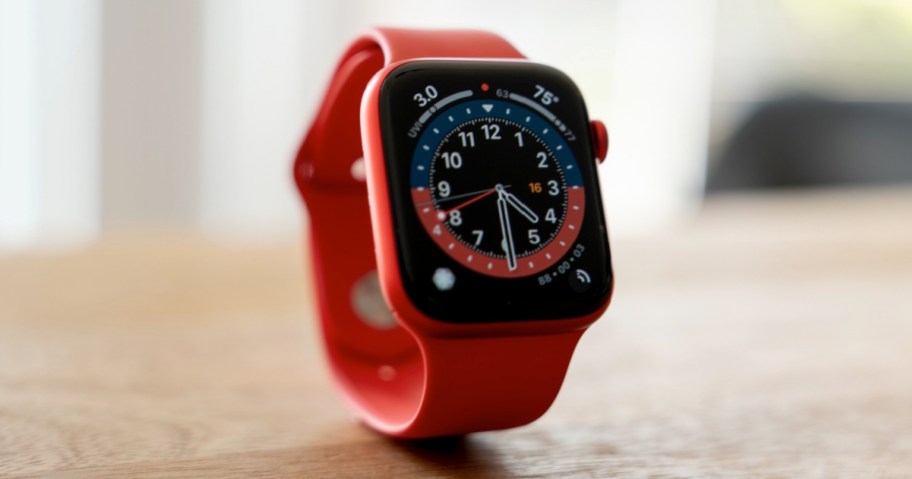 red smart watch standing up on table