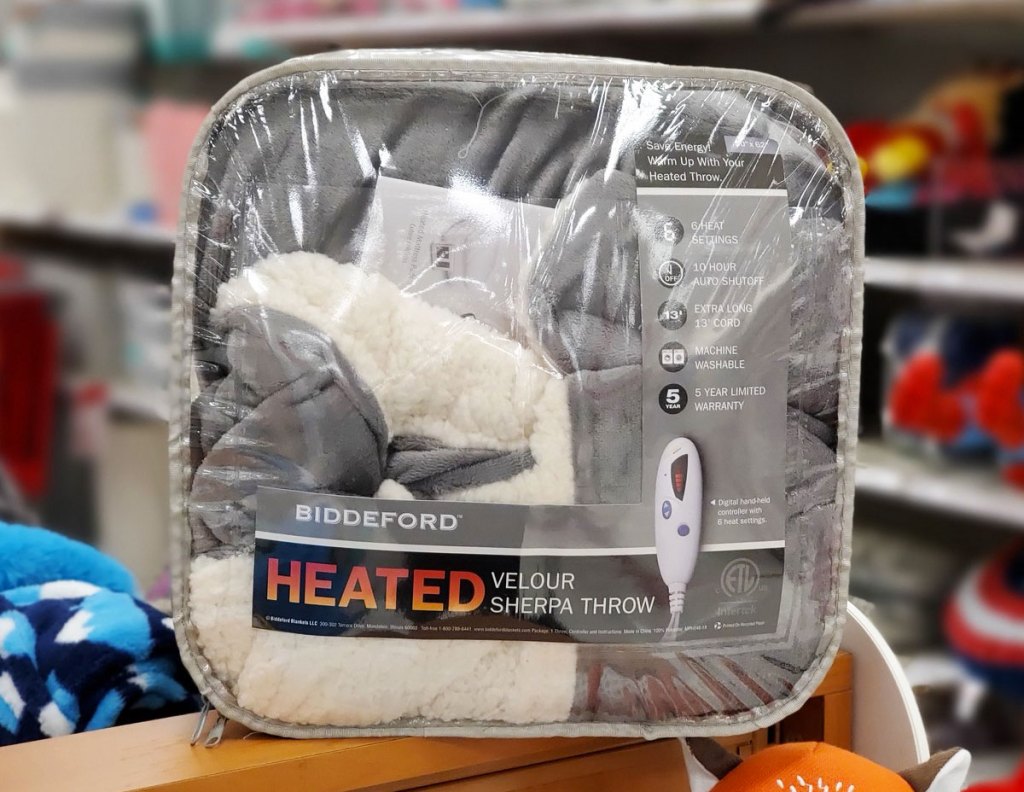 grey heated sherpa throw blanket on wood shelf