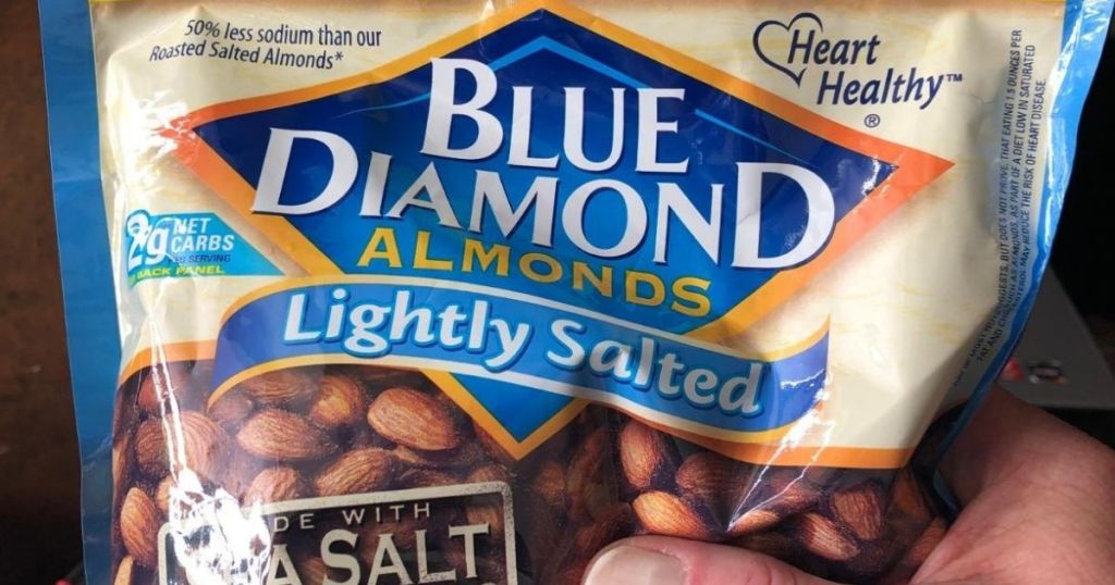 hand holding a bag of almonds