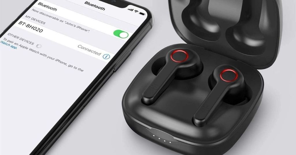 earbuds in case next to a phone