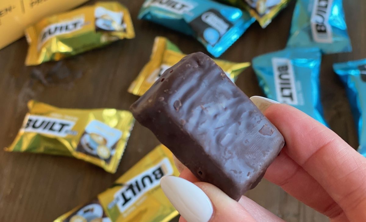 A hand holding a protein bar bite