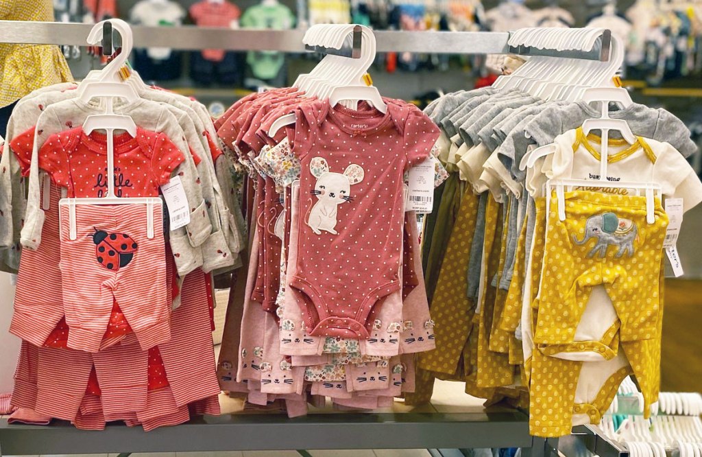carter's baby girls 3-piece sets on hangers on store display