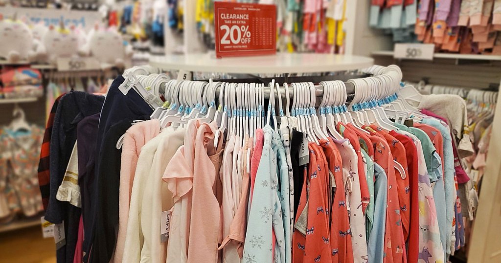 rack of kid's clearance apparel at carter's with extra 20% off sign