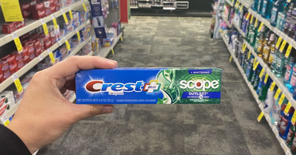 hand holding crest toothpaste